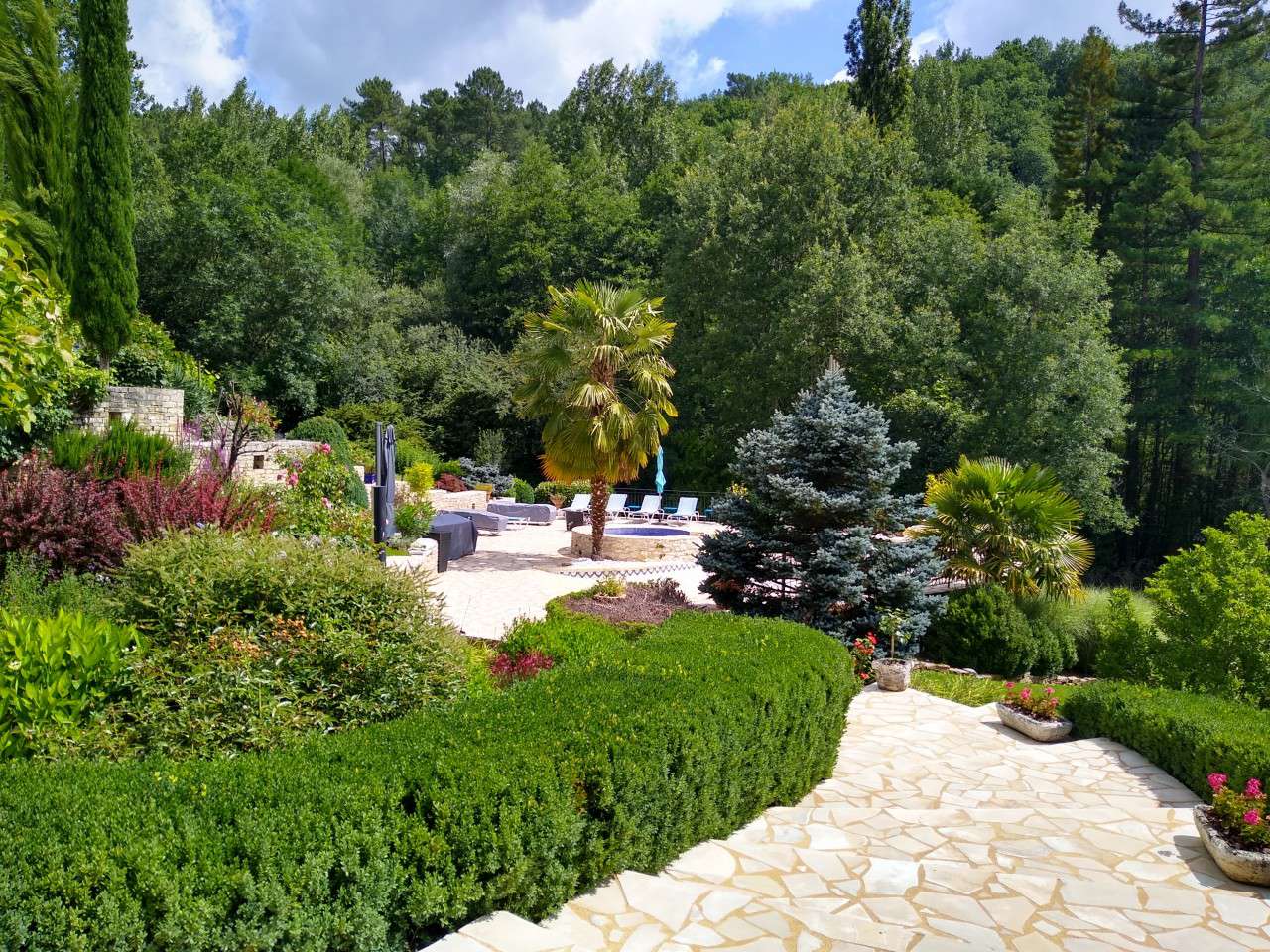 Nestling in nearly 10 acres of glorious landscaped gardens with trees and p