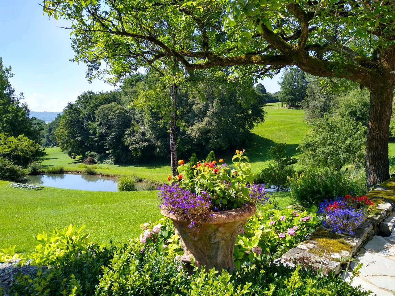 Nestling in nearly 10 acres of glorious landscaped gardens with trees and p