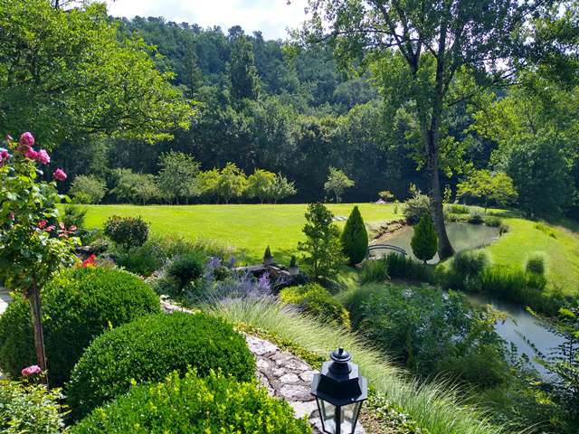 Nestling in nearly 10 acres of glorious landscaped gardens with trees and p