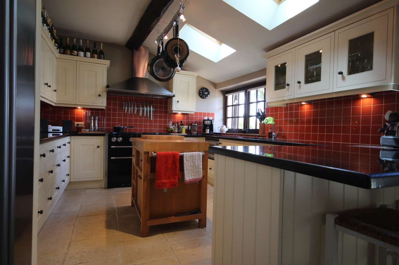 Surrounded by over 8 acres of glorious land with beautiful gardens, pond an