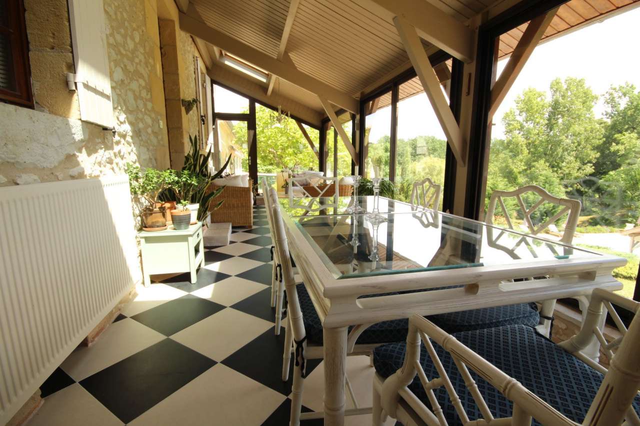 Surrounded by over 8 acres of glorious land with beautiful gardens, pond an