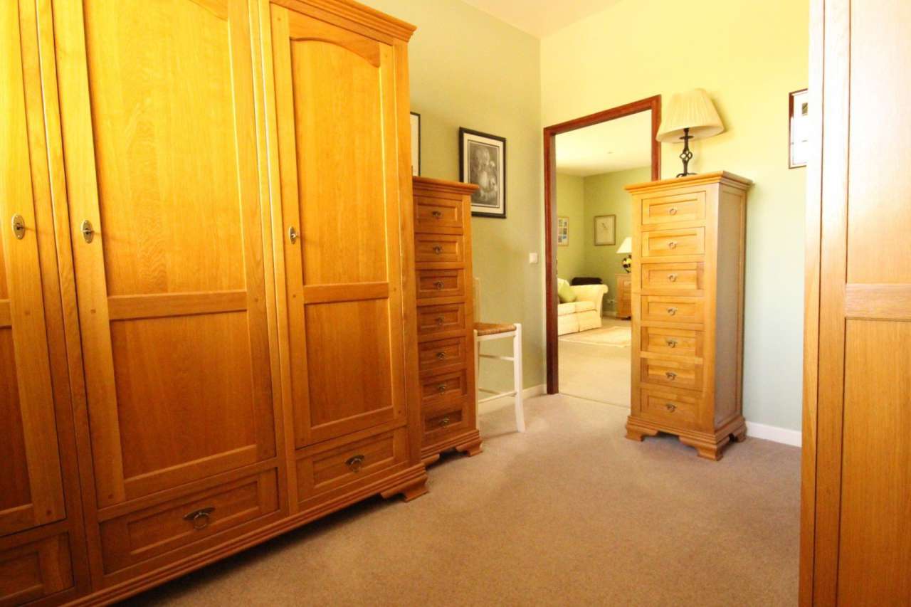 Surrounded by over 8 acres of glorious land with beautiful gardens, pond an