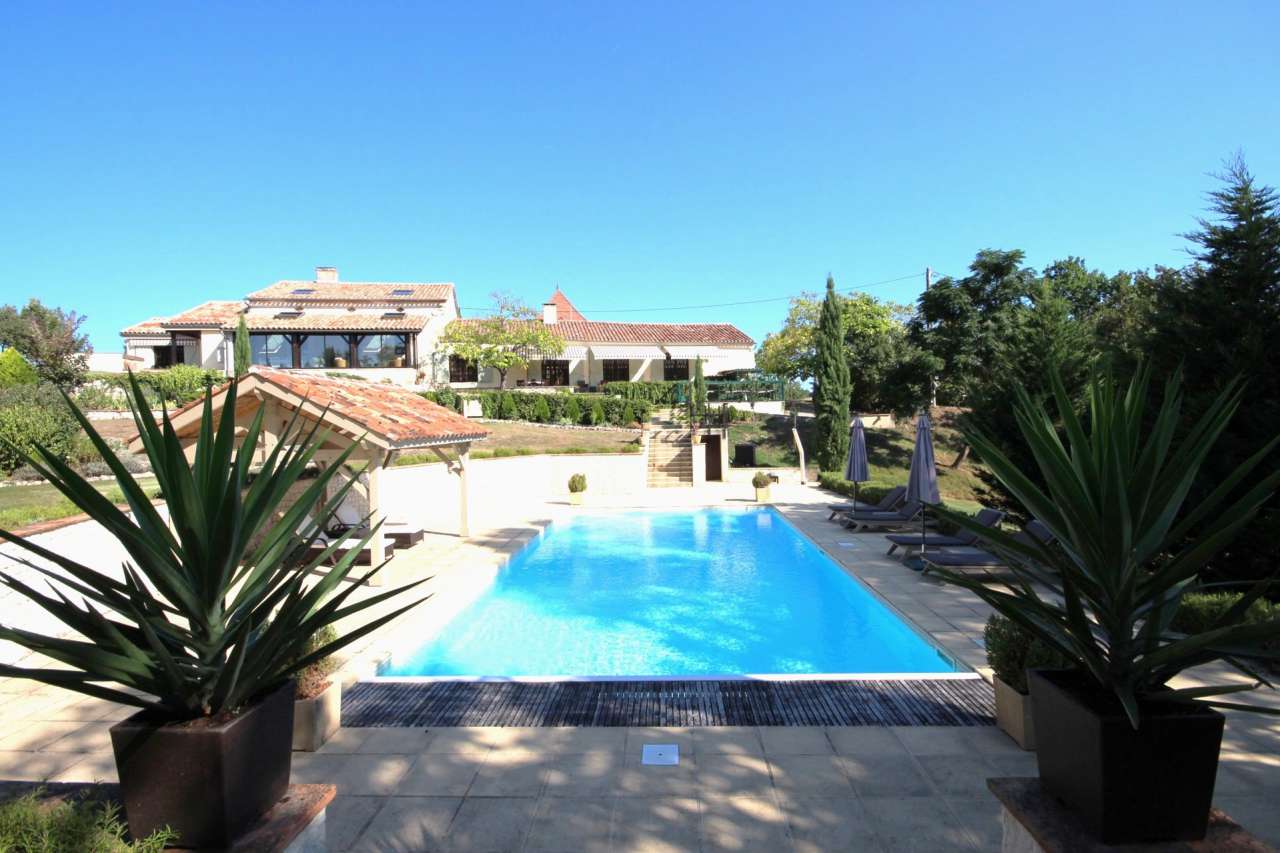 Surrounded by over 8 acres of glorious land with beautiful gardens, pond an