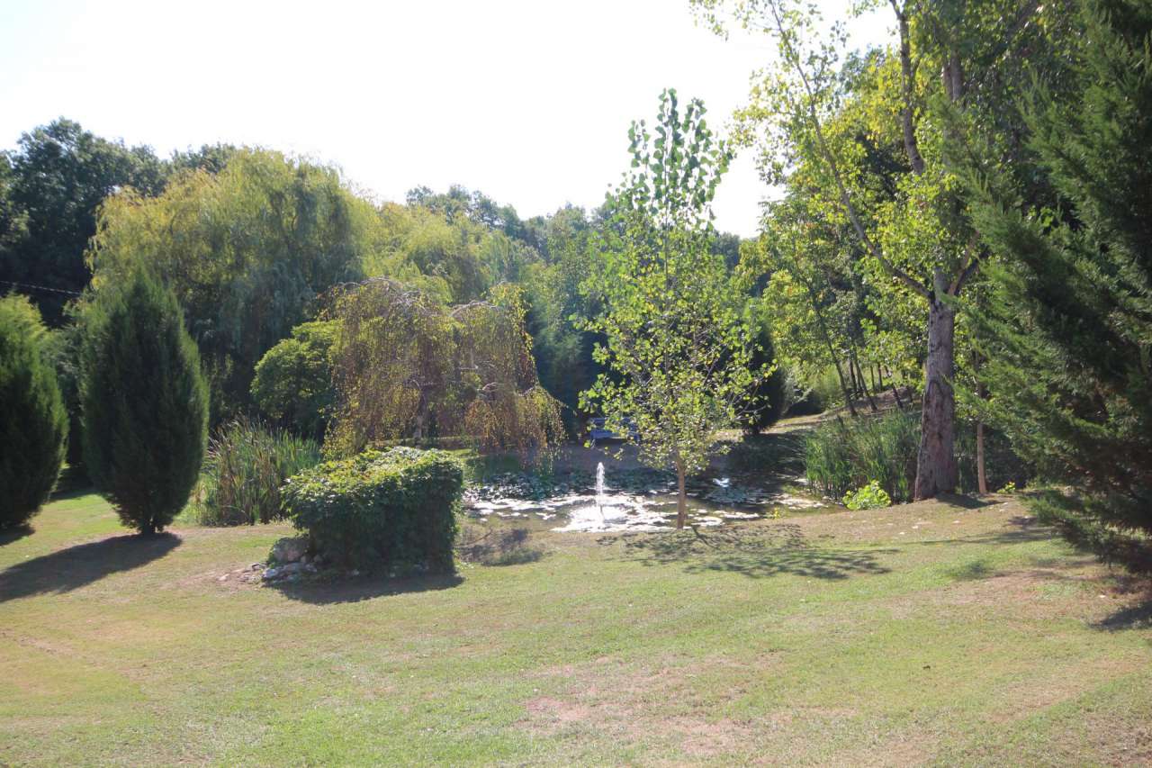 Surrounded by over 8 acres of glorious land with beautiful gardens, pond an