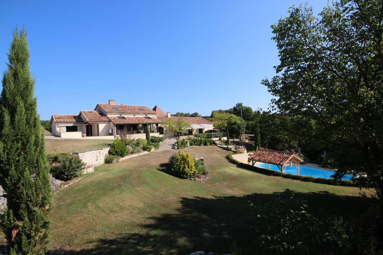 Surrounded by over 8 acres of glorious land with beautiful gardens, pond an