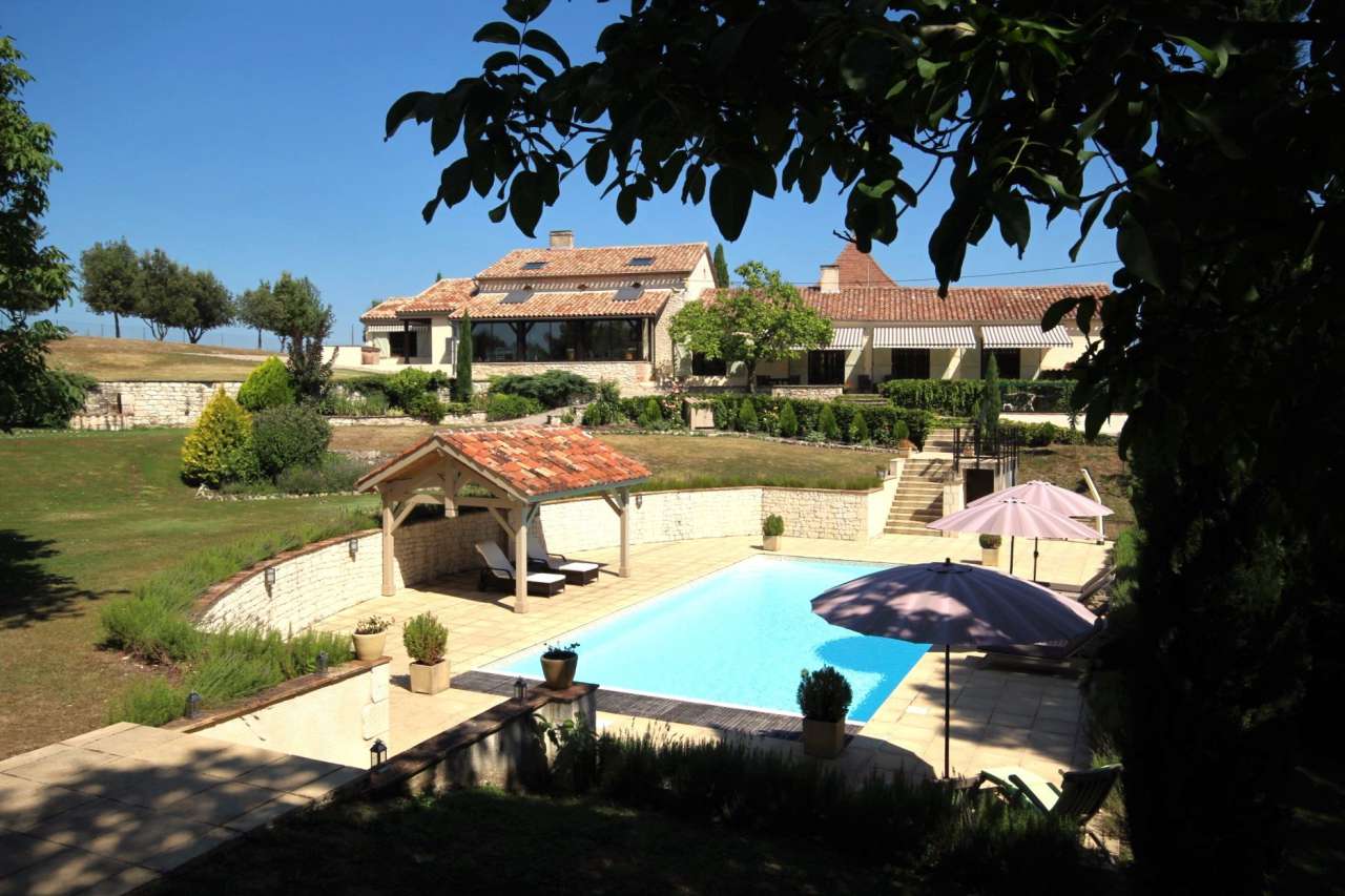 Surrounded by over 8 acres of glorious land with beautiful gardens, pond an