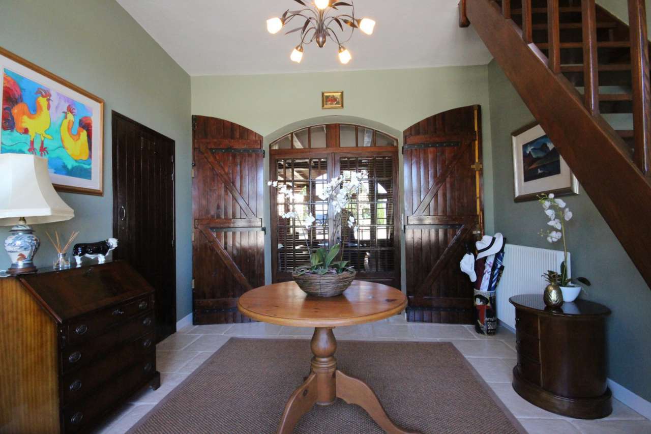 Surrounded by over 8 acres of glorious land with beautiful gardens, pond an