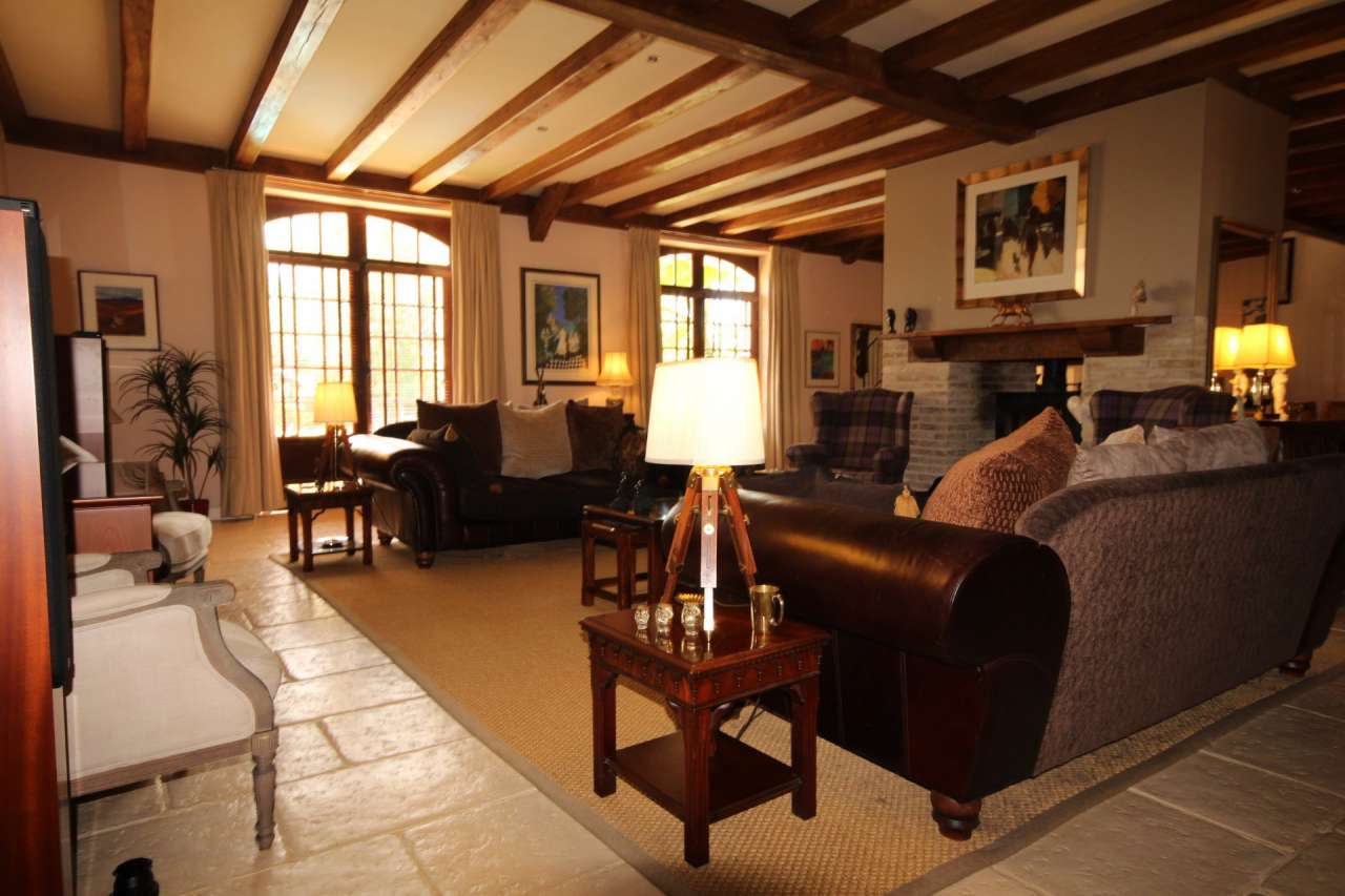 Surrounded by over 8 acres of glorious land with beautiful gardens, pond an