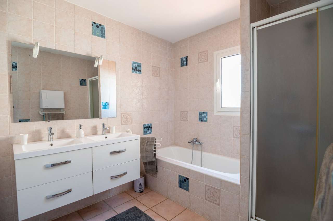 Nestling in 13.5 acres of beautiful landscaped gardens with expansive pool,