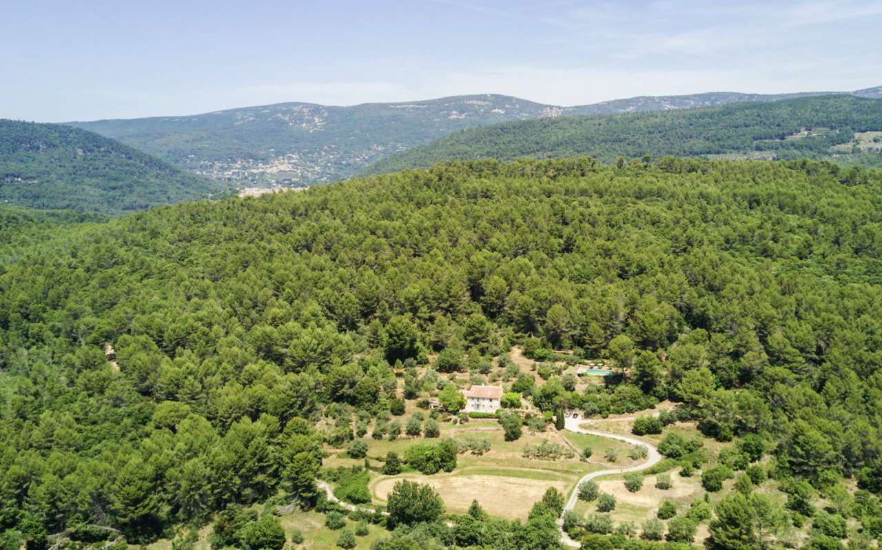 Surrounded by 26.5 acres of glorious land with amazing pool and gardens, is