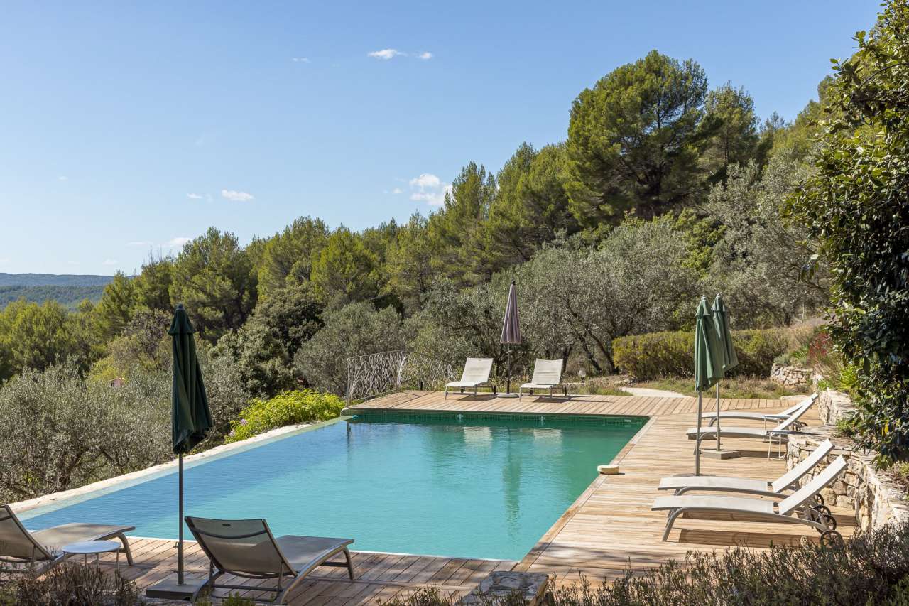 Surrounded by 26.5 acres of glorious land with amazing pool and gardens, is