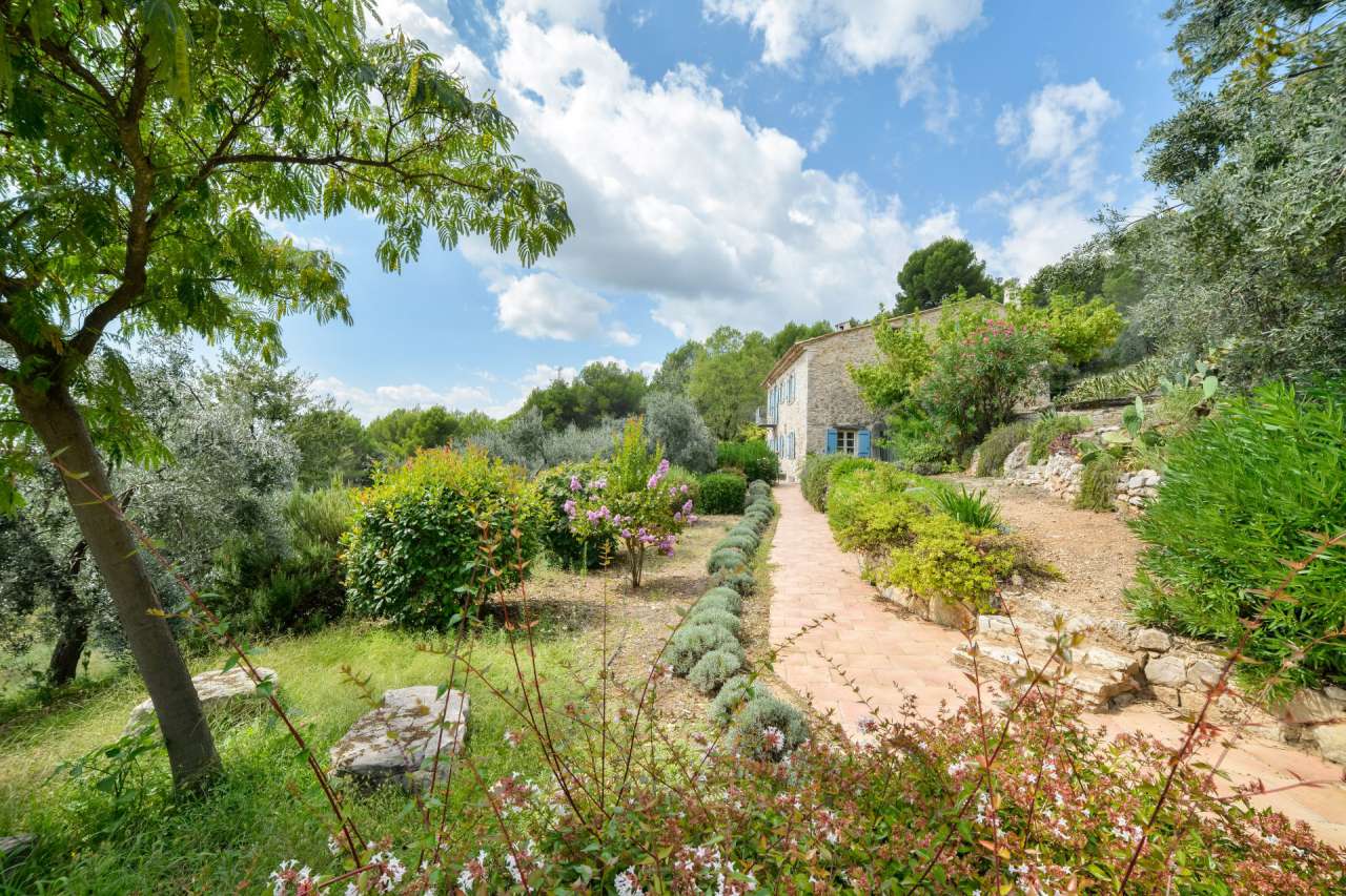 Surrounded by 26.5 acres of glorious land with amazing pool and gardens, is