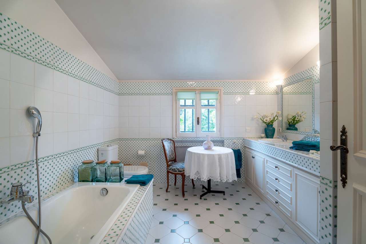 Nestling in over an acre of glorious landscaped gardens with expansive pool