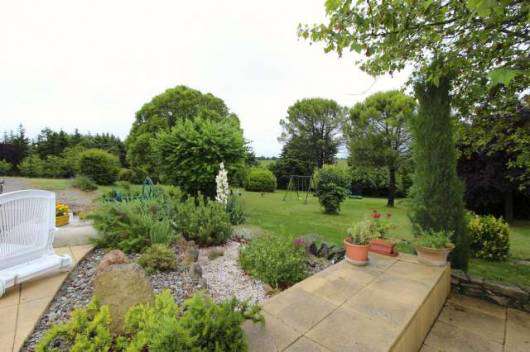Nestling in nearly 3 acres of glorious landscaped gardens with fruit trees,