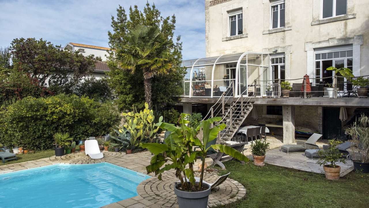 Nestling in an acre of beautiful landscaped gardens with pool, is this supe