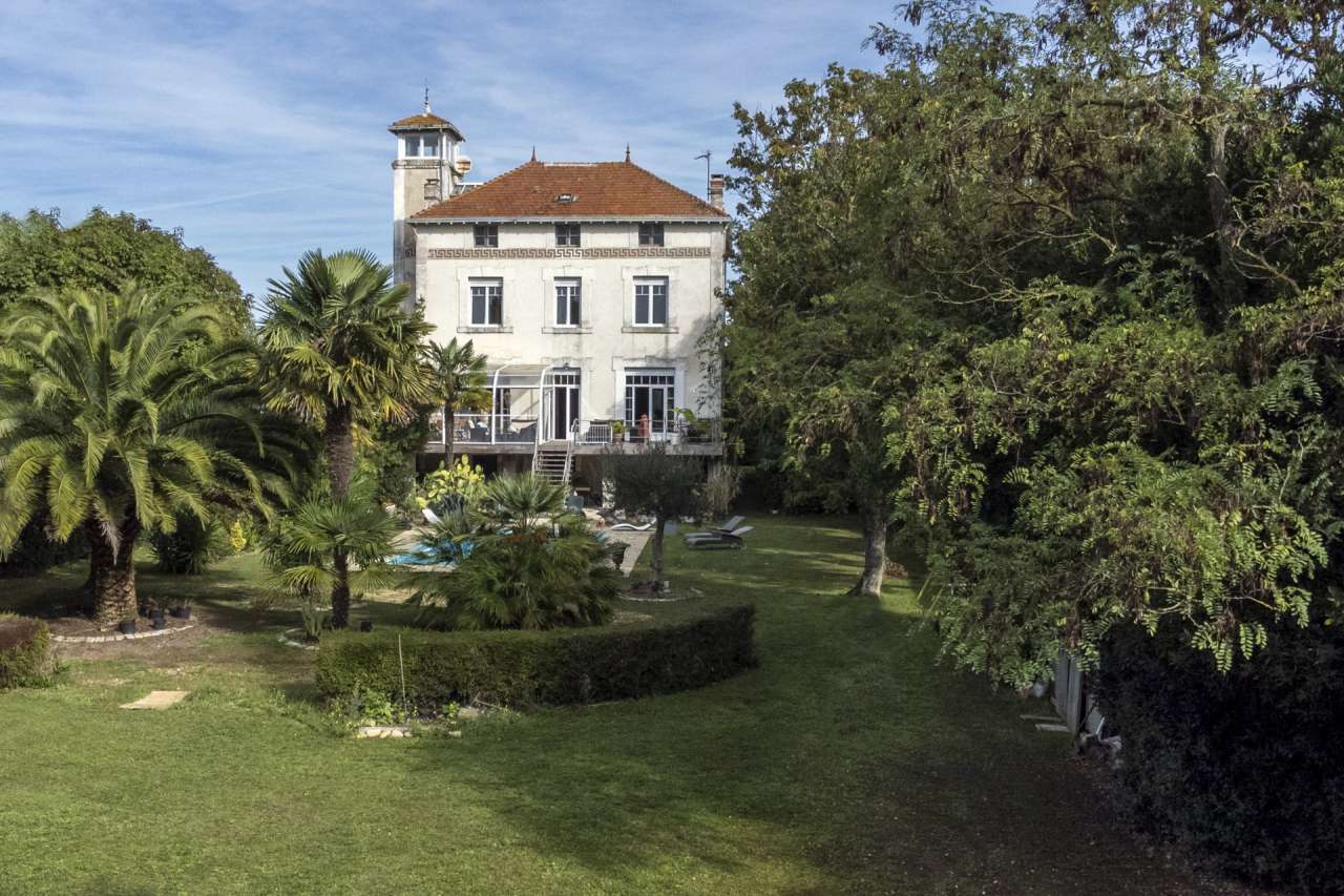 Nestling in an acre of beautiful landscaped gardens with pool, is this supe