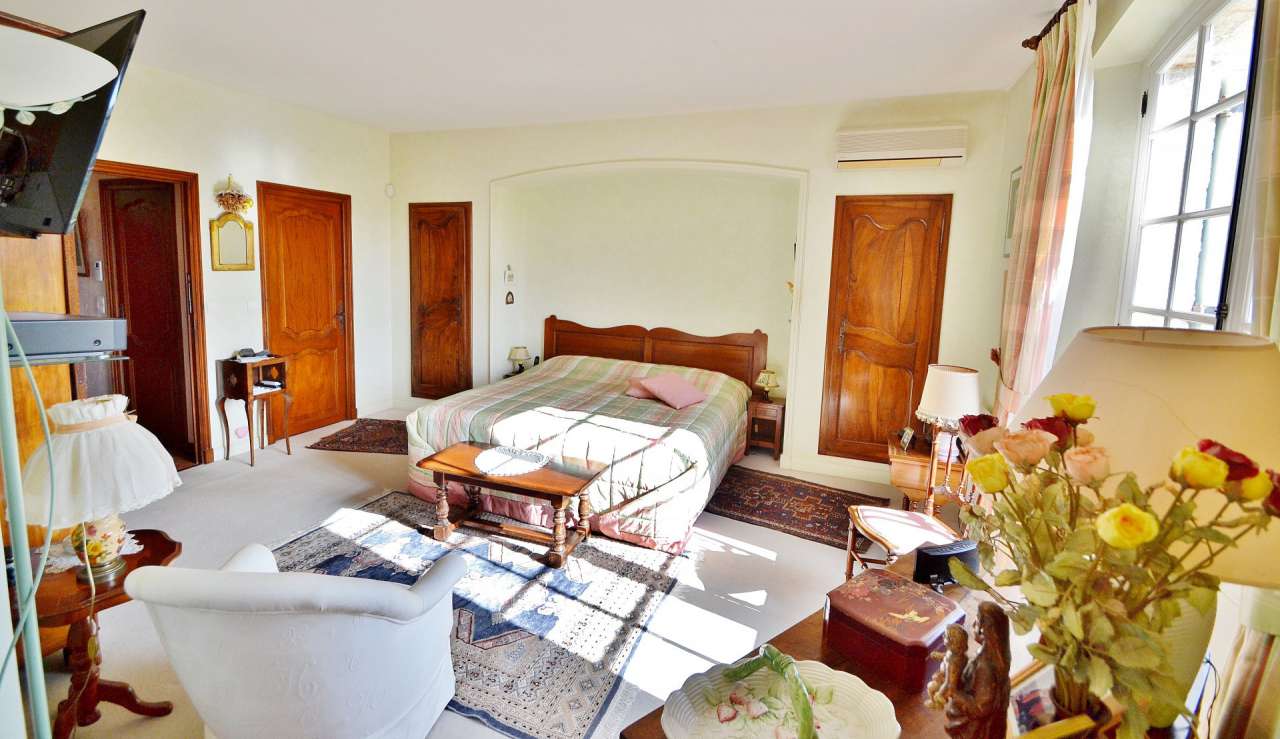 Nestling in nearly an acre of glorious landscaped gardens with pool, is thi