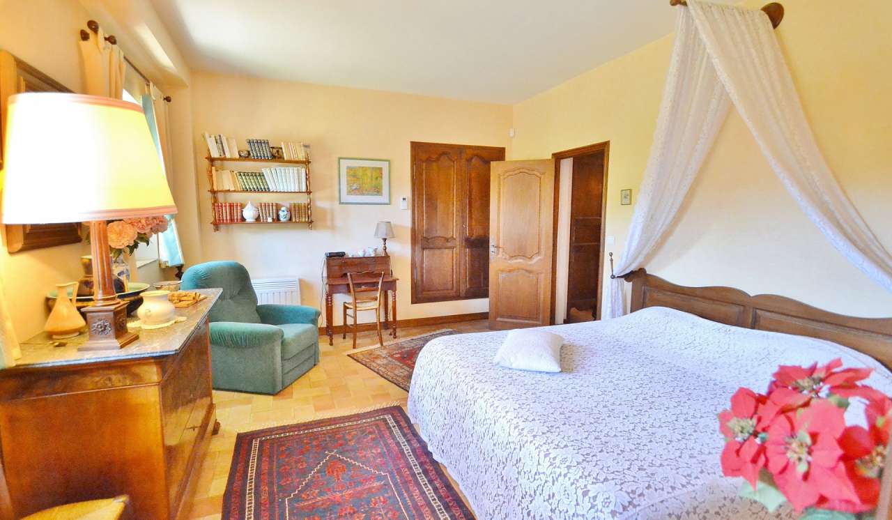 Nestling in nearly an acre of glorious landscaped gardens with pool, is thi