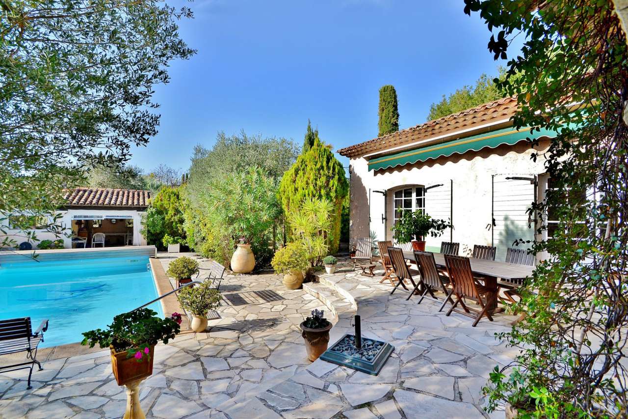 Nestling in nearly an acre of glorious landscaped gardens with pool, is thi