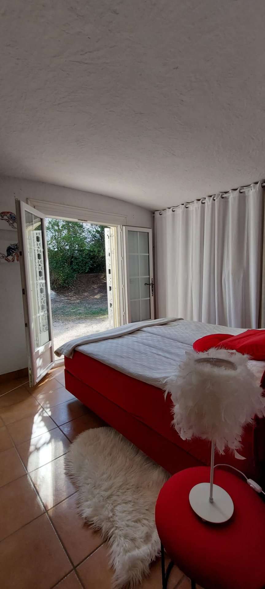 Nestling in beautiful landscaped gardens with pool, is this stylishly renov