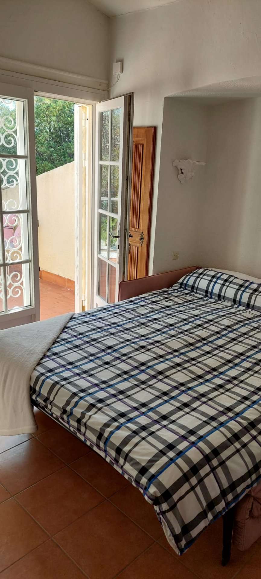 Nestling in beautiful landscaped gardens with pool, is this stylishly renov