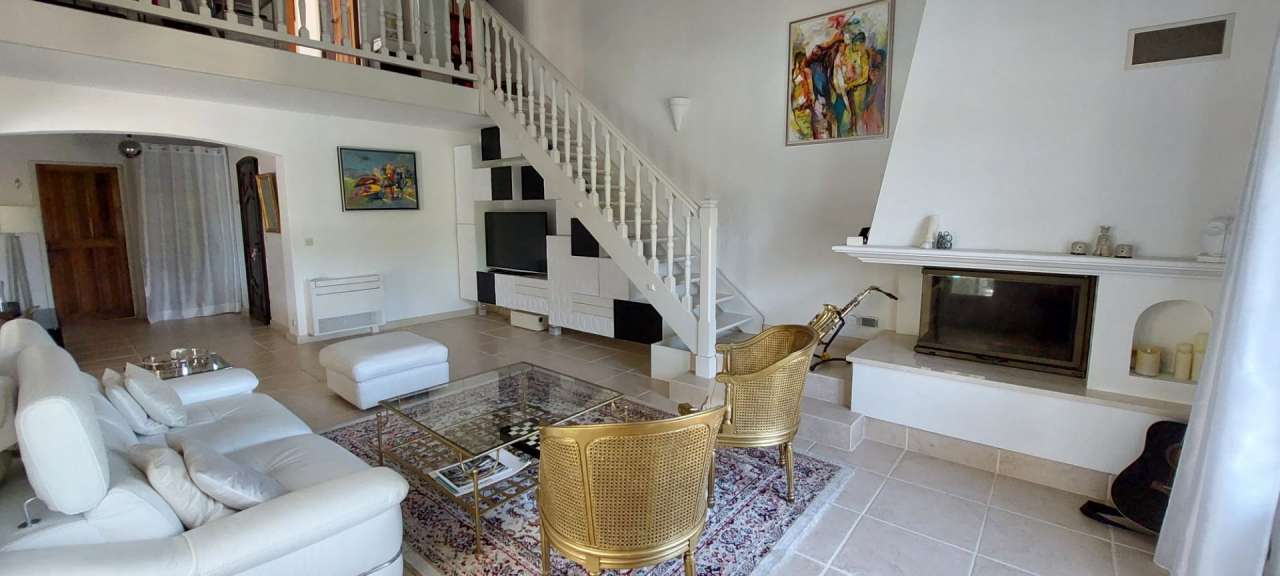 Nestling in beautiful landscaped gardens with pool, is this stylishly renov