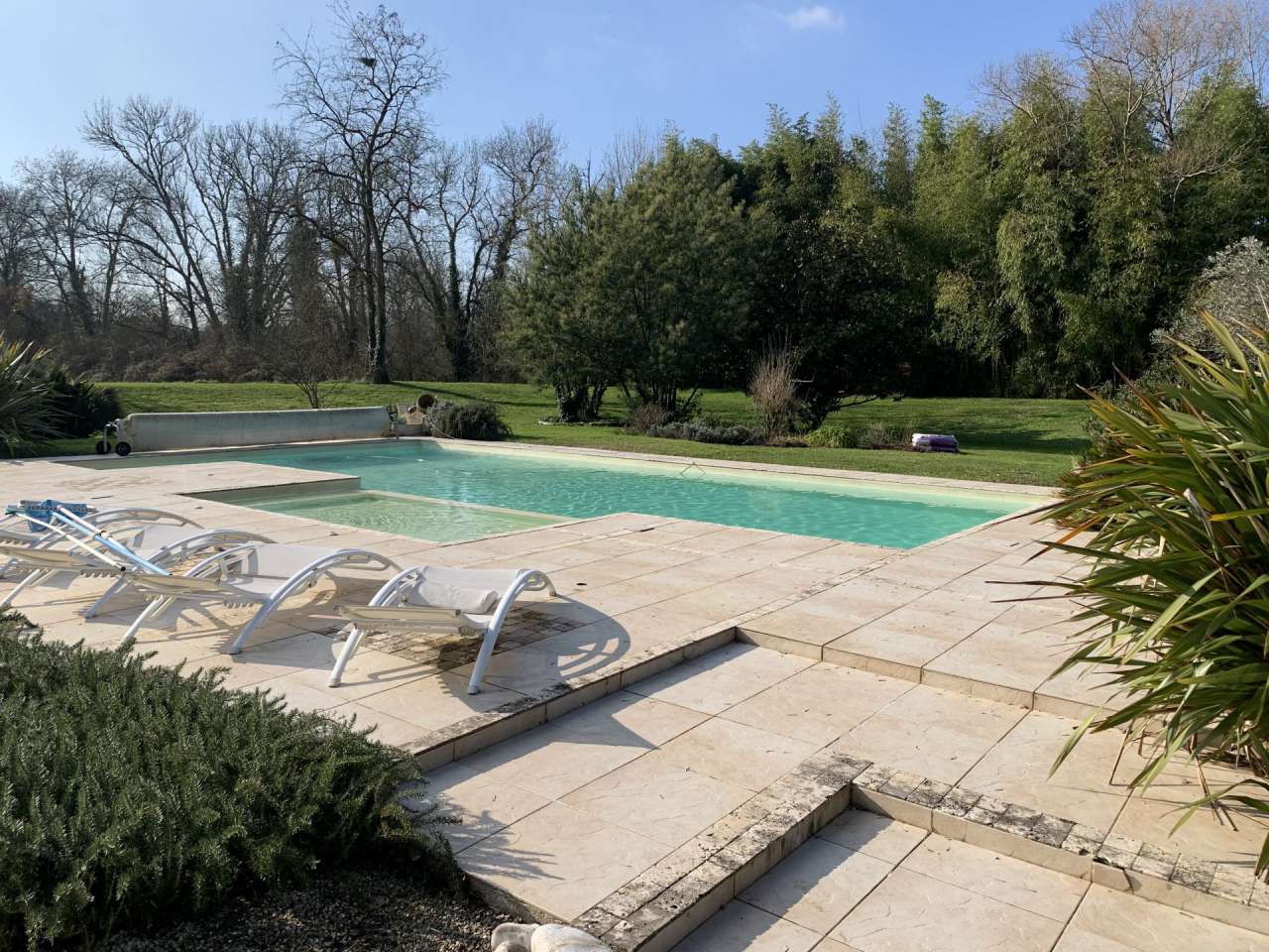 Nestling in over 9 acres of glorious landscaped gardens with expansive pool