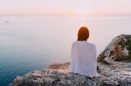 An expat looks at the coastal view near her Algarve villa for sale.