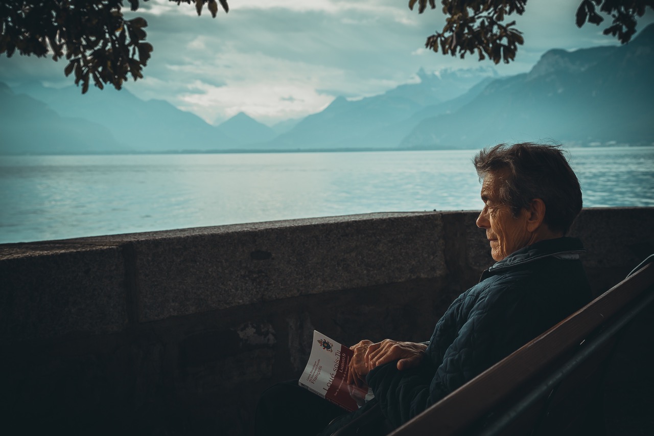 elderly man looking over lake